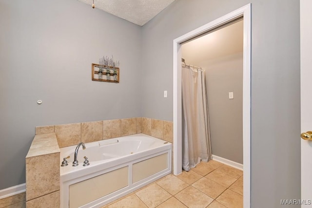 full bath with a textured ceiling, baseboards, a bath, and tile patterned floors