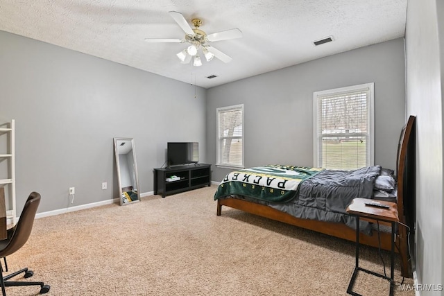 bedroom featuring baseboards, visible vents, a textured ceiling, and carpet flooring