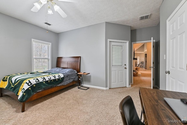 carpeted bedroom featuring a ceiling fan, visible vents, a textured ceiling, and baseboards