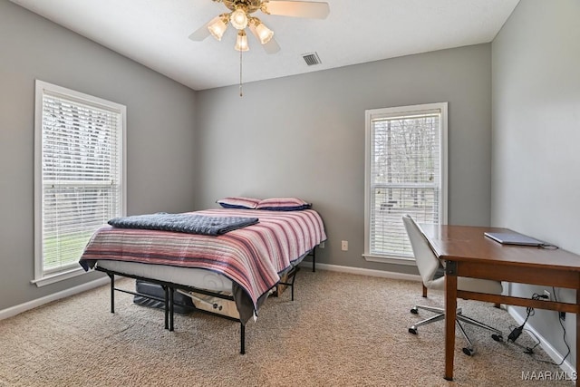 bedroom with light colored carpet, visible vents, and baseboards