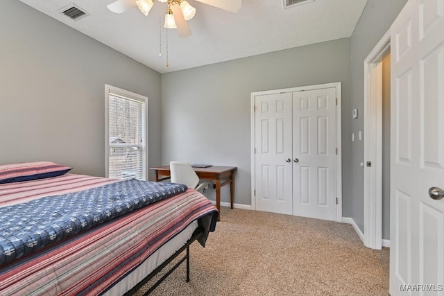 bedroom featuring baseboards, a closet, visible vents, and light colored carpet