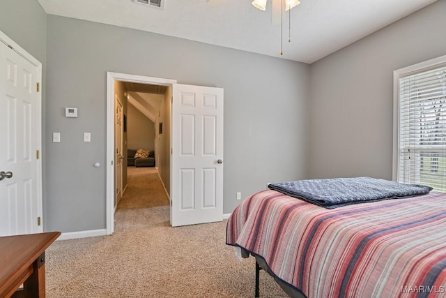 bedroom with carpet floors, visible vents, and baseboards