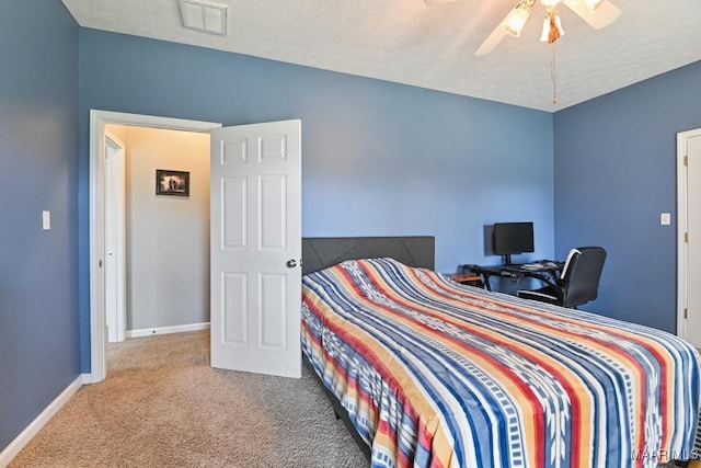 bedroom featuring carpet floors, visible vents, ceiling fan, a textured ceiling, and baseboards