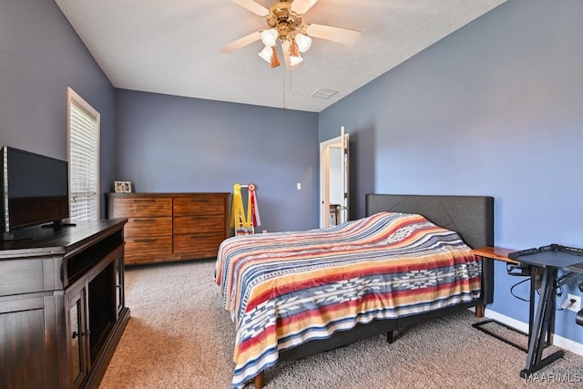 bedroom featuring a ceiling fan, light carpet, and baseboards