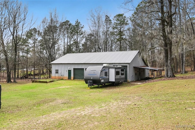 view of side of property with driveway, a garage, a lawn, and an outbuilding