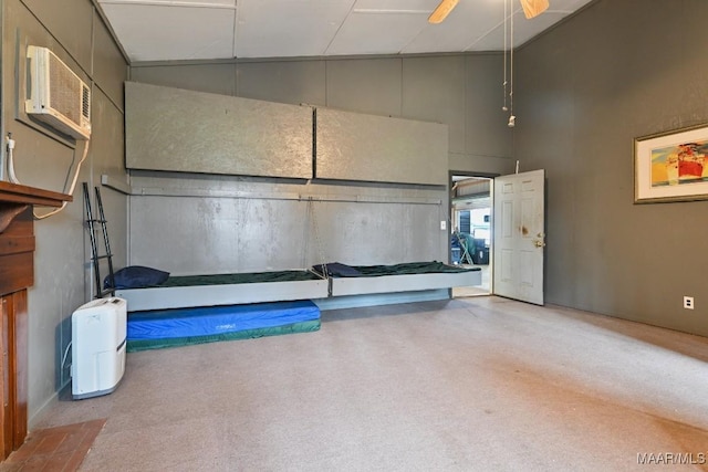 garage featuring an AC wall unit and a ceiling fan