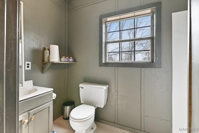 half bathroom with toilet and vanity