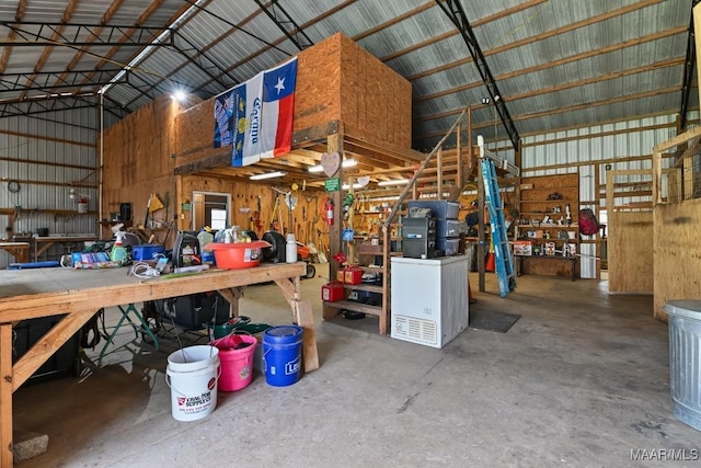 garage with metal wall and a workshop area