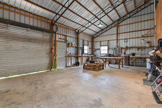 garage with a workshop area and metal wall