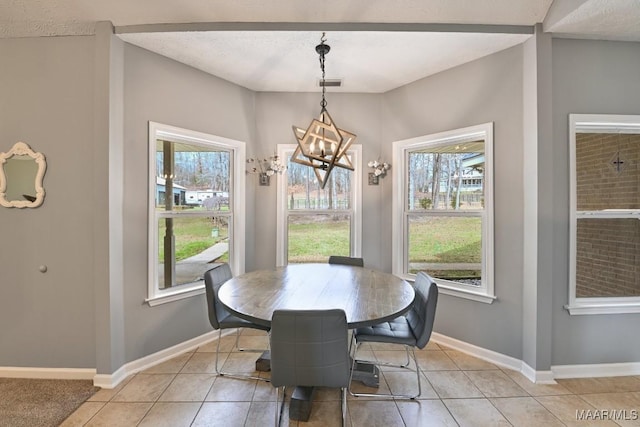 dining space featuring light tile patterned floors, baseboards, visible vents, and an inviting chandelier