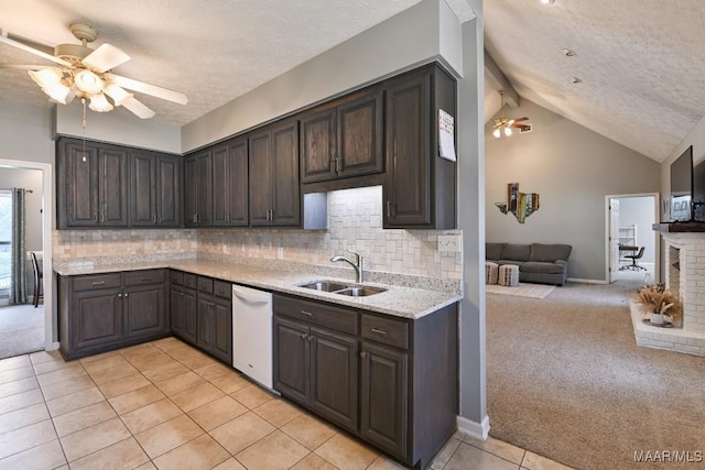 kitchen with light carpet, dark brown cabinetry, a sink, and dishwasher