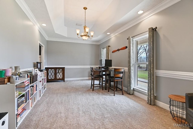 dining room with ornamental molding, a raised ceiling, light colored carpet, and baseboards