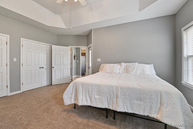 carpeted bedroom with ceiling fan and baseboards