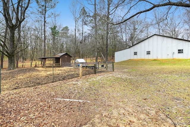 view of yard featuring an outbuilding, a pole building, and a carport