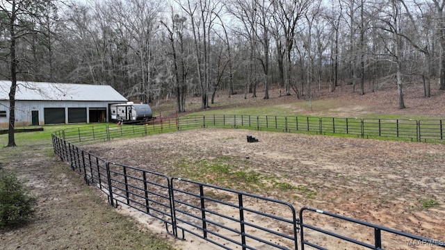 view of yard with a rural view and an enclosed area