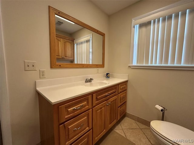 bathroom featuring visible vents, baseboards, toilet, tile patterned floors, and vanity