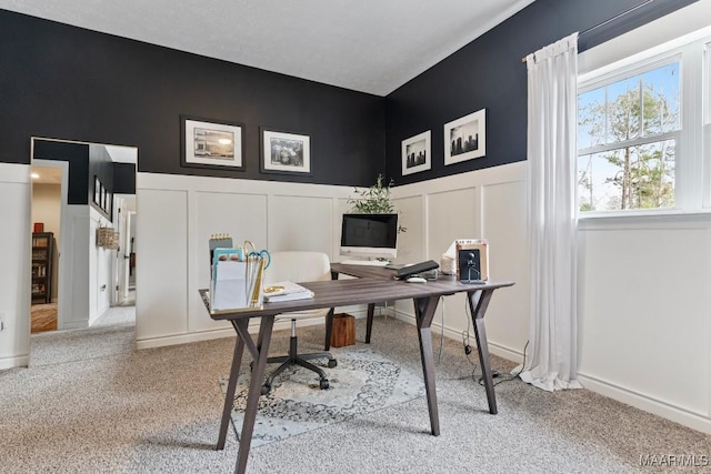 office area with light carpet and a decorative wall