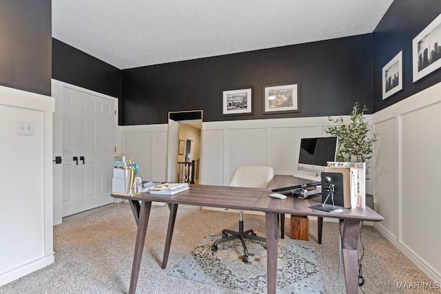 carpeted office with wainscoting and a decorative wall