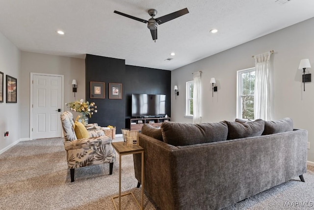 living room featuring recessed lighting, light carpet, and baseboards