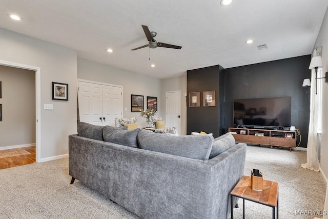 living area featuring recessed lighting, light carpet, visible vents, baseboards, and a ceiling fan