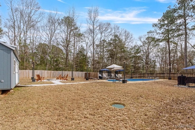 view of yard featuring a fenced in pool and a fenced backyard