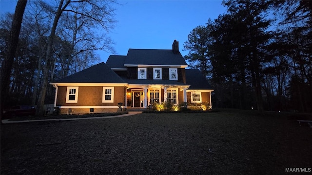 view of front of house with a porch and a chimney