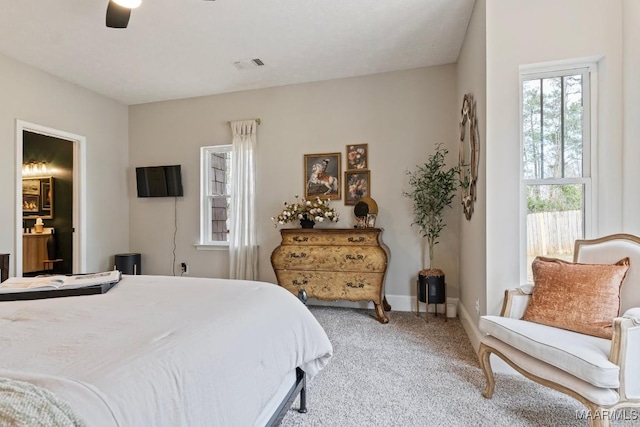 bedroom featuring ceiling fan, carpet flooring, visible vents, and baseboards