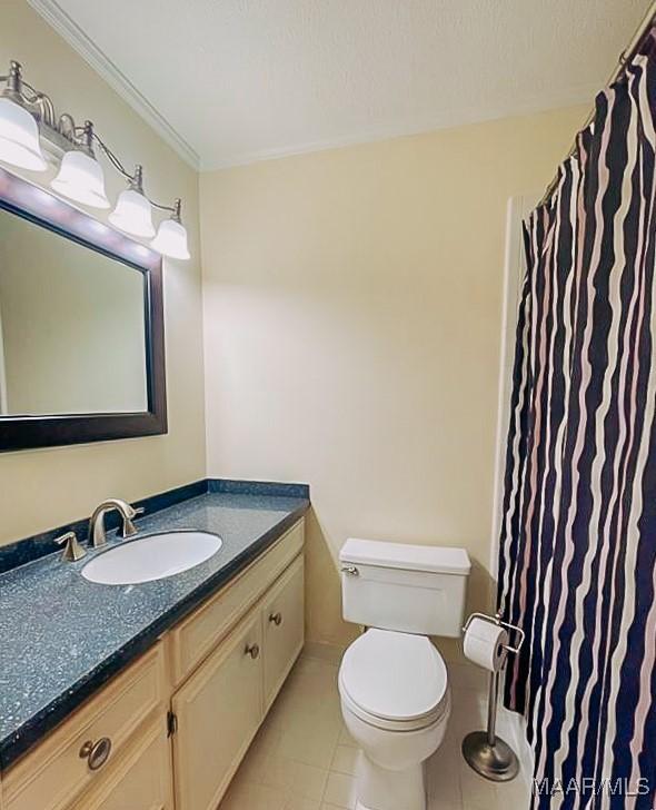 full bathroom with toilet, tile patterned floors, crown molding, and vanity