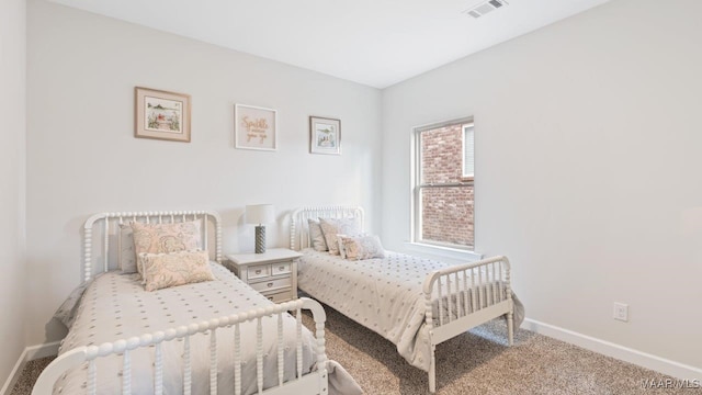 bedroom featuring baseboards, visible vents, and carpet flooring