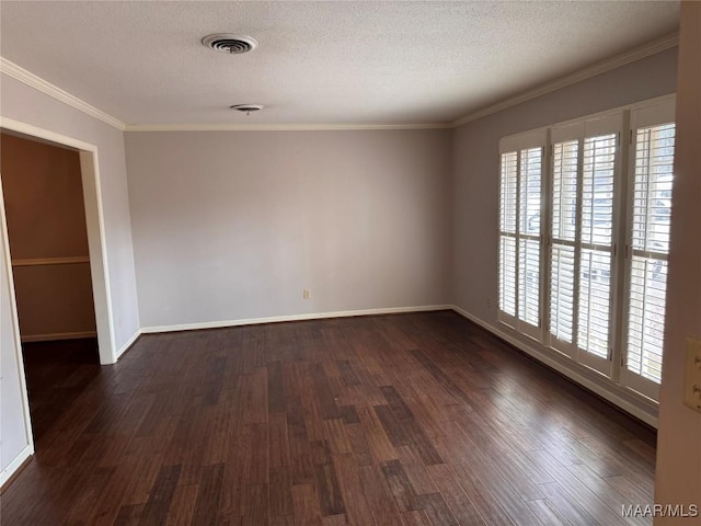 unfurnished room featuring dark wood-style floors, visible vents, ornamental molding, and a textured ceiling