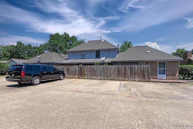 view of parking featuring fence