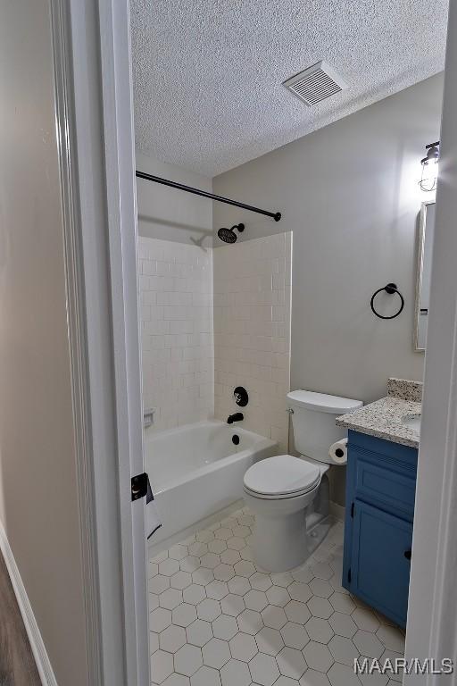 full bathroom with a textured ceiling, toilet, vanity, visible vents, and washtub / shower combination