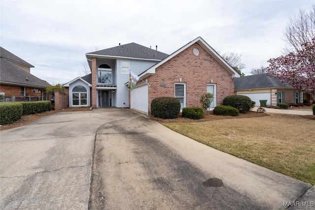 traditional-style house with a garage, brick siding, driveway, and a front lawn