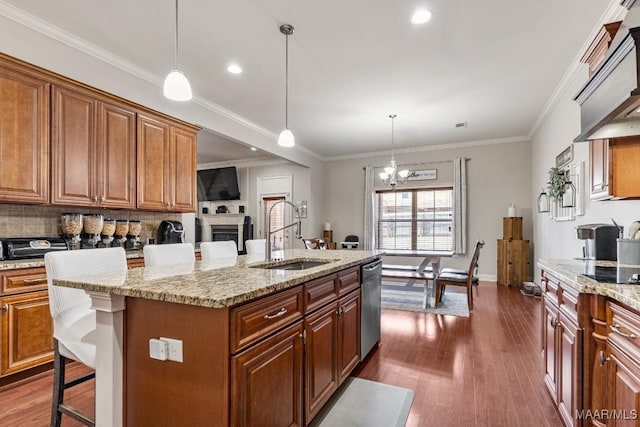 kitchen with dark wood-style flooring, a sink, stainless steel dishwasher, a kitchen breakfast bar, and a notable chandelier