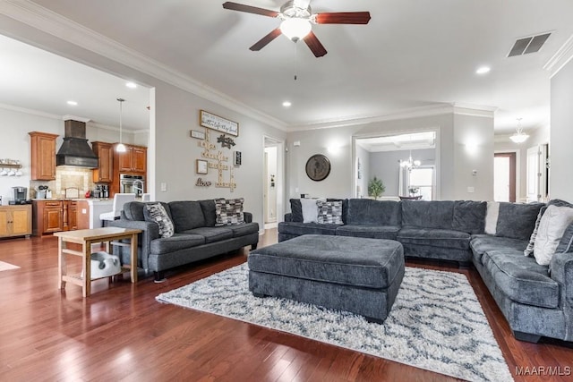 living area featuring visible vents, crown molding, ceiling fan with notable chandelier, recessed lighting, and dark wood-style floors