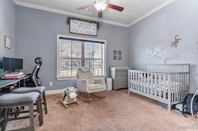 carpeted bedroom featuring ceiling fan, baseboards, a nursery area, and ornamental molding