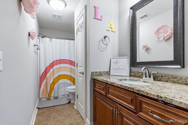 bathroom with tile patterned flooring, visible vents, baseboards, toilet, and vanity