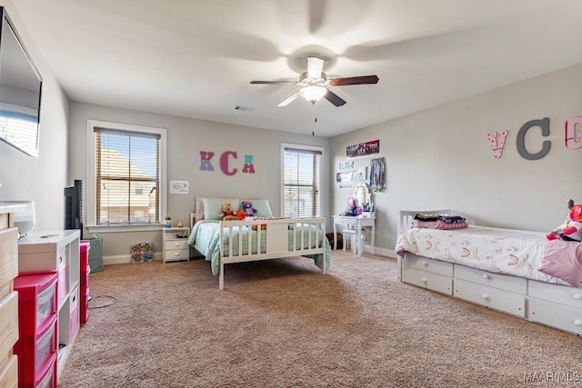 carpeted bedroom featuring visible vents, baseboards, and a ceiling fan