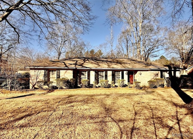 ranch-style home with a front lawn