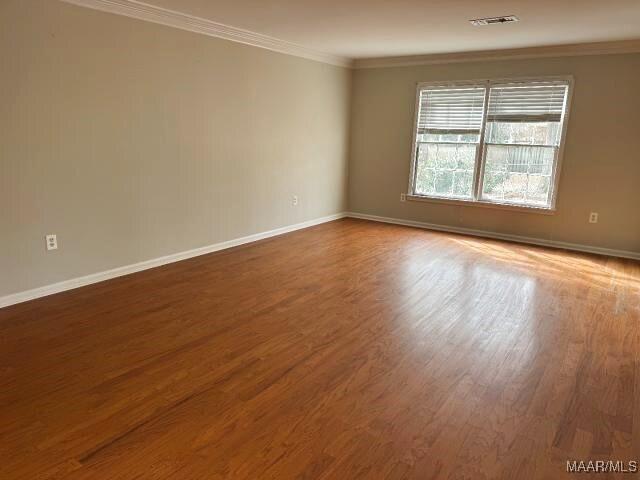 3110 Highfield Dr, Montgomery, AL 36111 - empty room with baseboards, visible vents, wood finished floors, and ornamental molding