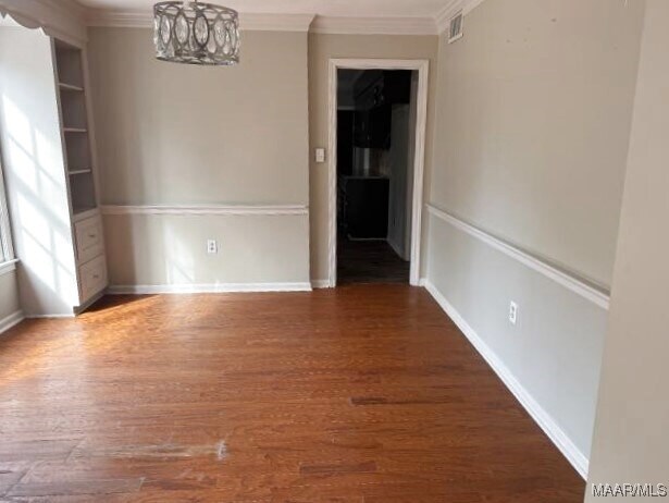 3110 Highfield Dr, Montgomery, AL 36111 - empty room with crown molding, a notable chandelier, dark wood finished floors, visible vents, and baseboards