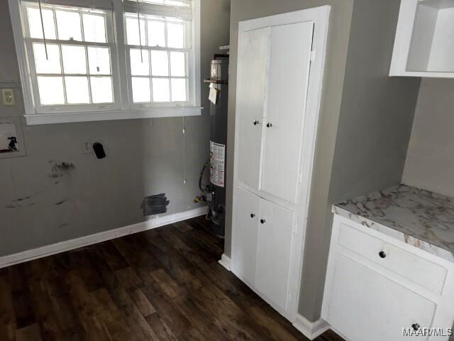 3110 Highfield Dr, Montgomery, AL 36111 - laundry area with cabinet space, baseboards, dark wood-style floors, hookup for a washing machine, and electric dryer hookup