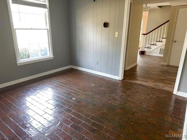3110 Highfield Dr, Montgomery, AL 36111 - unfurnished room featuring brick floor, stairs, and baseboards
