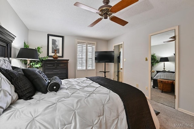 bedroom featuring carpet floors, a textured ceiling, baseboards, and a ceiling fan