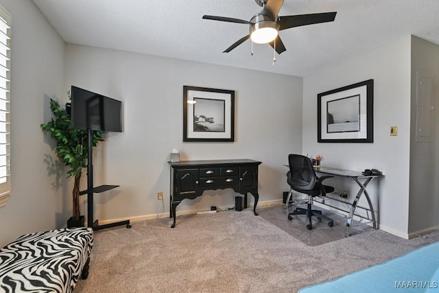 carpeted office featuring a ceiling fan, a textured ceiling, and baseboards