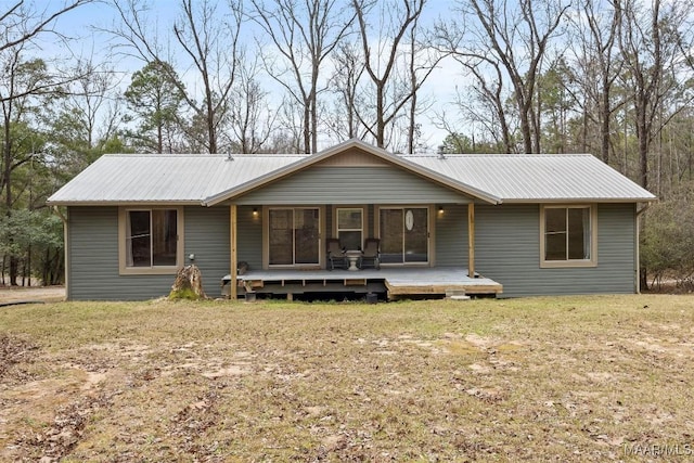 single story home with metal roof and a front lawn