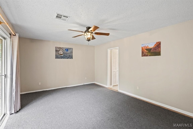 empty room featuring ceiling fan, a textured ceiling, visible vents, baseboards, and carpet