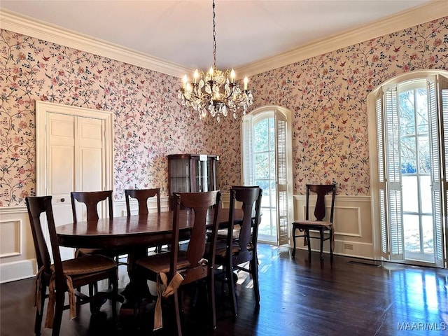 dining area featuring arched walkways, wainscoting, dark wood-style floors, wallpapered walls, and crown molding