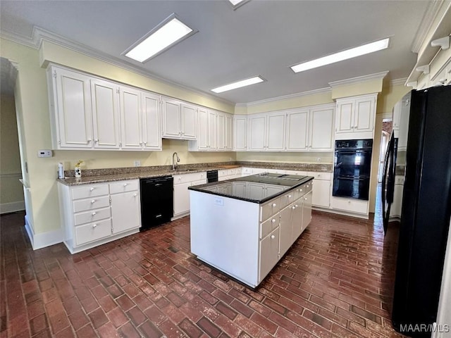 kitchen featuring baseboards, dark countertops, a kitchen island, black appliances, and white cabinetry