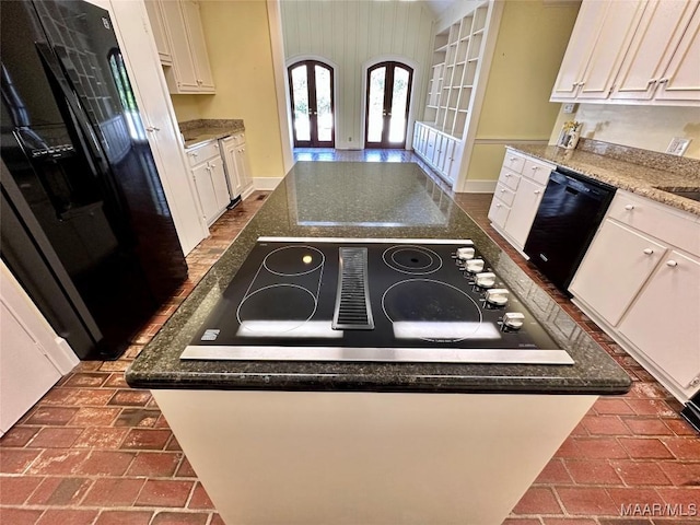 kitchen featuring black appliances, white cabinets, and a center island